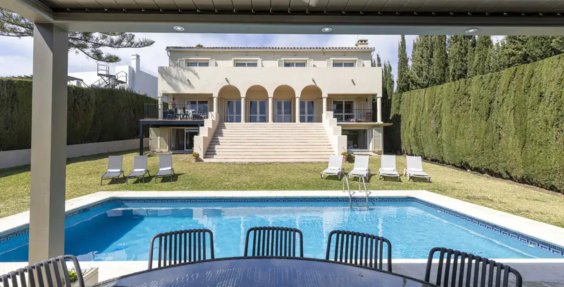 7 bedroom Villa Calle - poolside dining view to villa - luxury villas Marbella